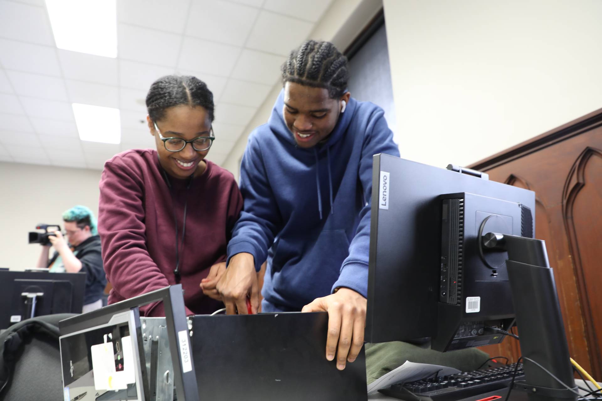 Two students working on a computer.