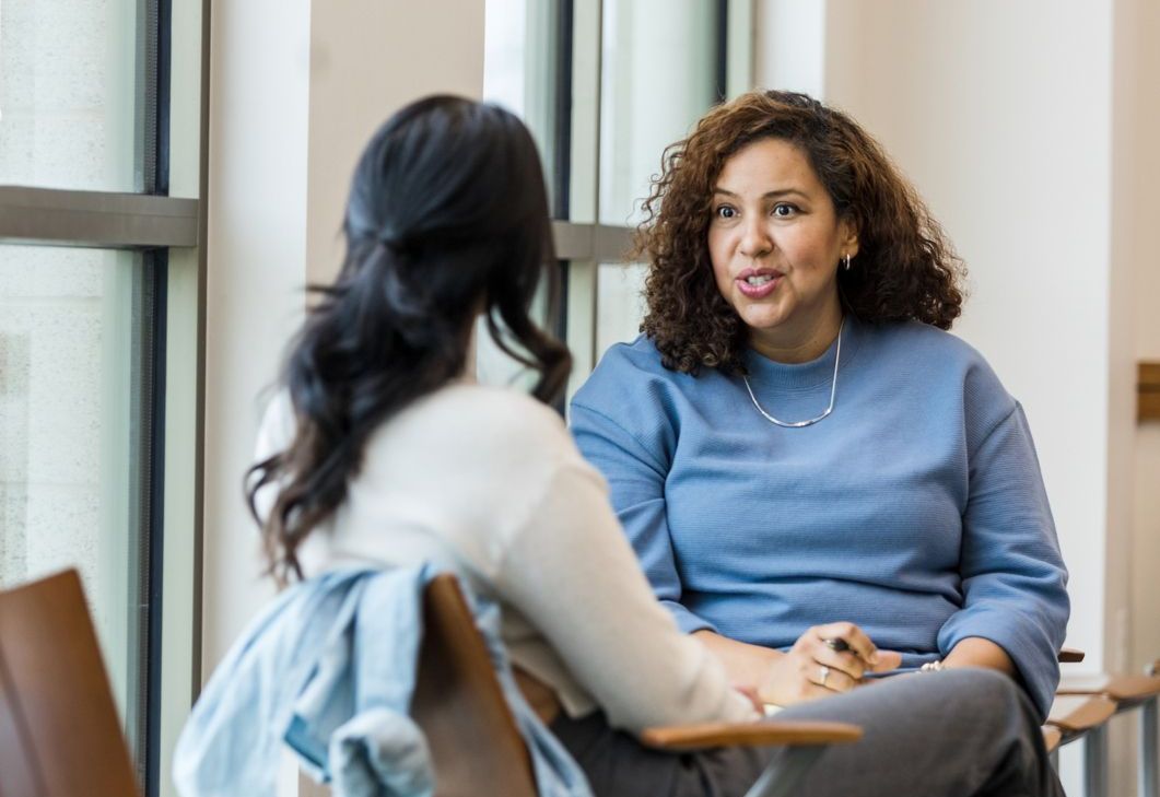 Public Health worker sitting and discussing something with another woman