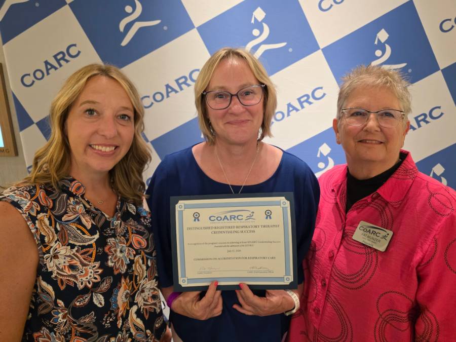 Three people holding up a certificate for the Earns Distinguished RRT Credentialing Success Award in front of a coARC Gridded background